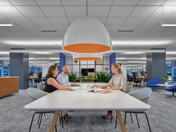 small group of people sitting at a table having a meeting