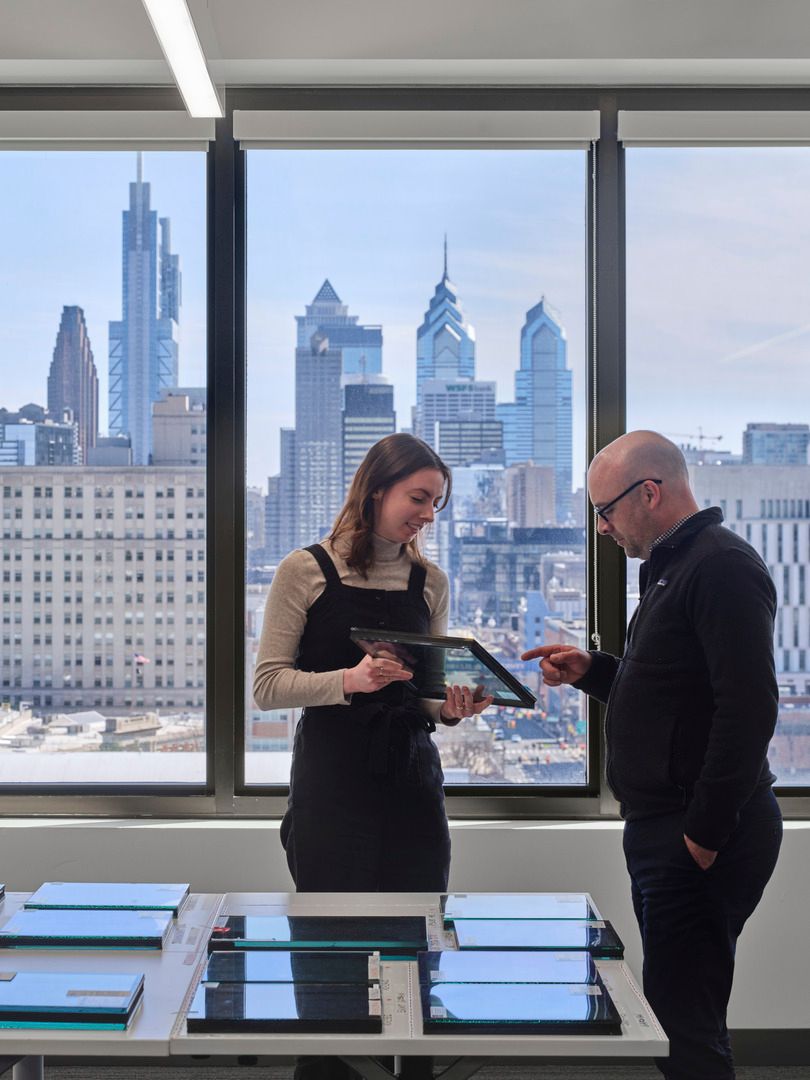 Two people looking at glass materials in a library